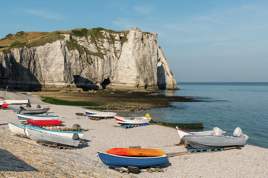 Boats In Front Of The Halk Cliffs Of Etretat With The Natural Arch Porte Daval And The Stone Needle Called Laiguille Photograph