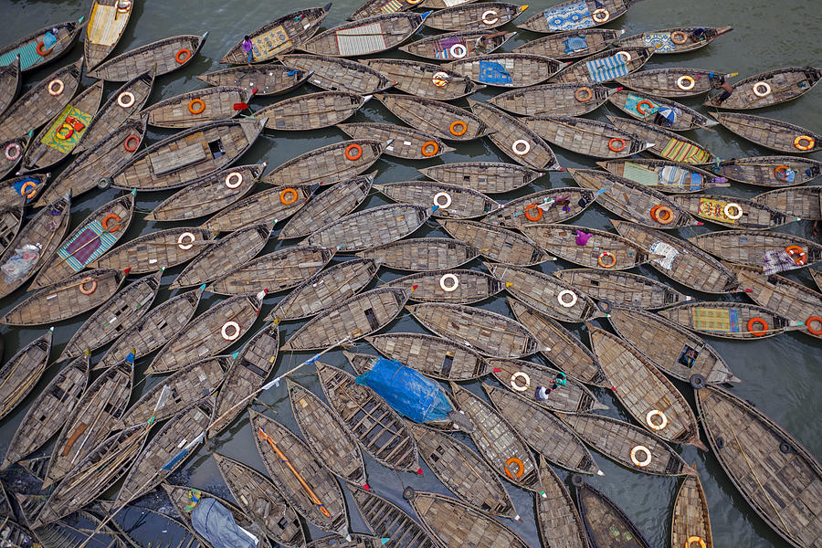 Boat Photograph - Boats Laid Out Like Petals With Life Saving Rings by Azim Khan Ronnie