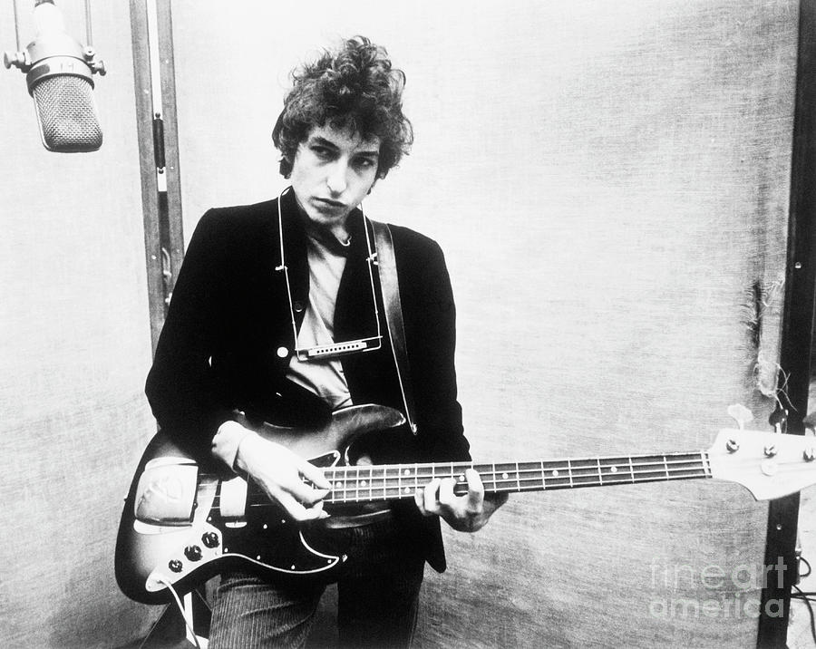 Bob Dylan Photograph - Bob Dylan Holding Bass Guitar by Bettmann