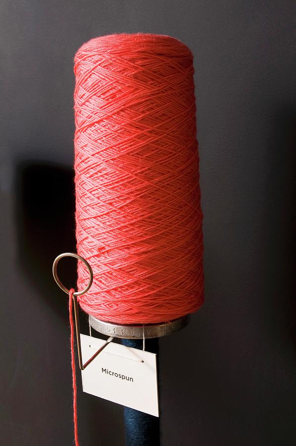 Bobbin Of Red Yarn With Label Photograph by Erik Rank
