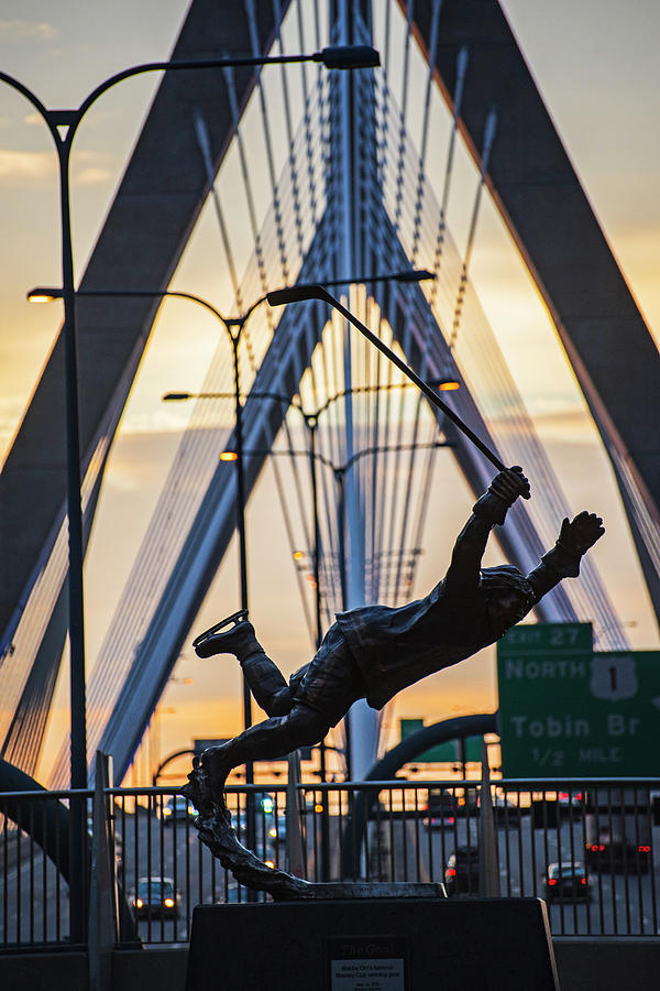 Bobby Orr Statue leaping through the Zakim Bridge at Sunset Boston MA Photograph by Toby McGuire