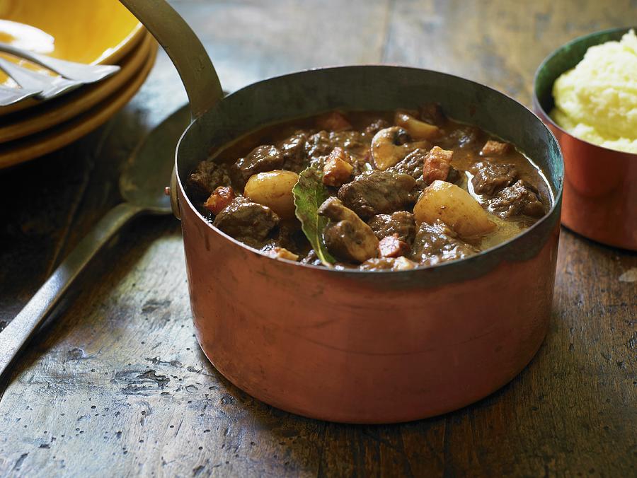 Boeuf Bourguignon Cooking In A Pot beef Burgundy Photograph by Clive Streeter