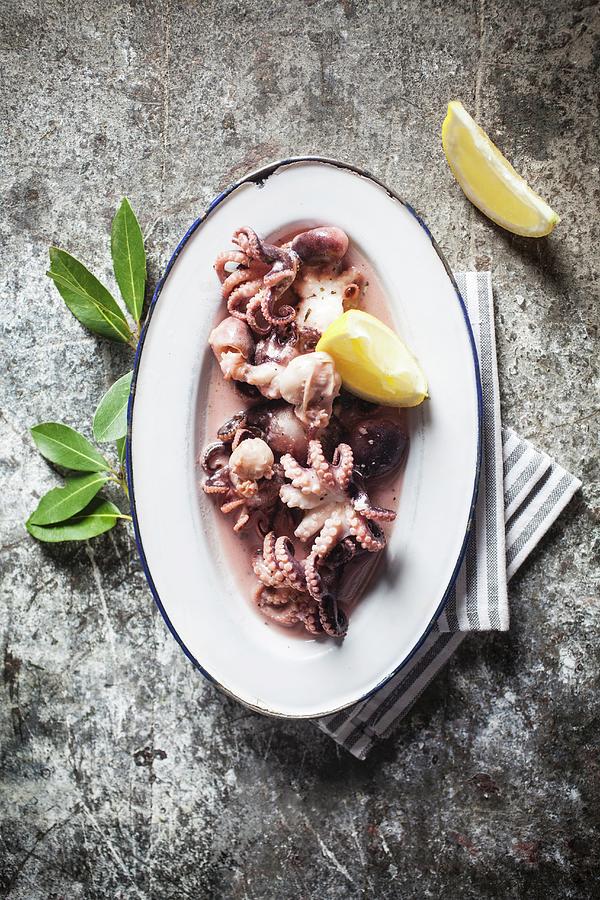 Boiled Baby Octopus With Lemon Wedges Photograph by Malgorzata Stepien