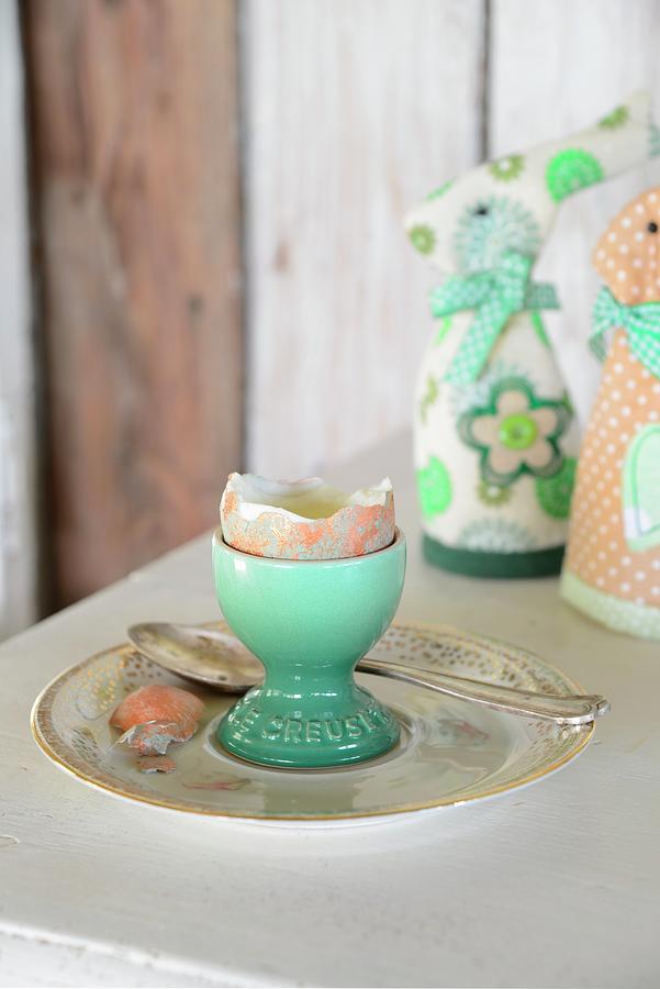 Boiled Egg With Top Removed In Turquoise Eggcup In Front Of Textile Rabbit-shaped Egg Warmers Photograph by Revier 51