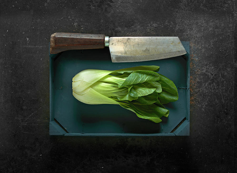 Bok Choy In A Wooden Crate With A Meat Cleaver Photograph by Christoph Maria Hnting