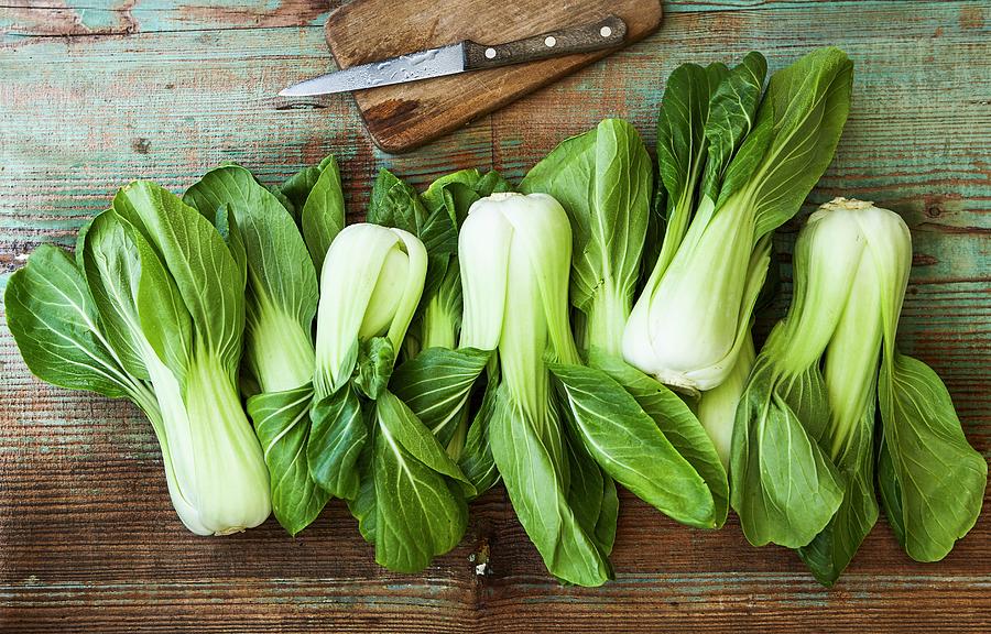 Bok Choy With A Knife On A Wooden Board Photograph by Kai Schwabe