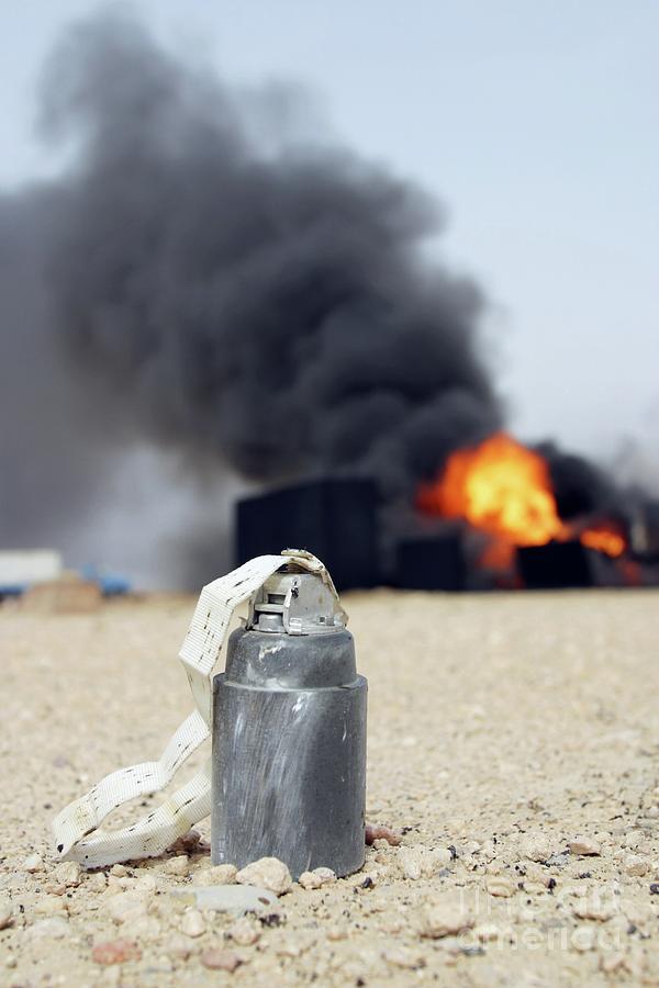 Bomb With Oil Well Fire Photograph by Peter Menzel/science Photo Library