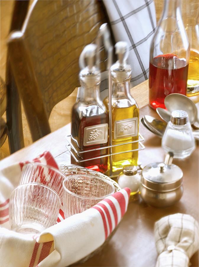Bottle Of Oil And Vinaigar On A Table In A Bistrot Photograph by Studio