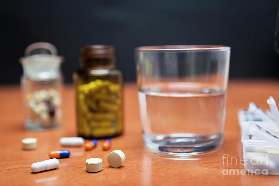 Bottle Of Pills Along With A Few Pills On A Wooden Table Photograph by Digicomphoto/science Photo Library