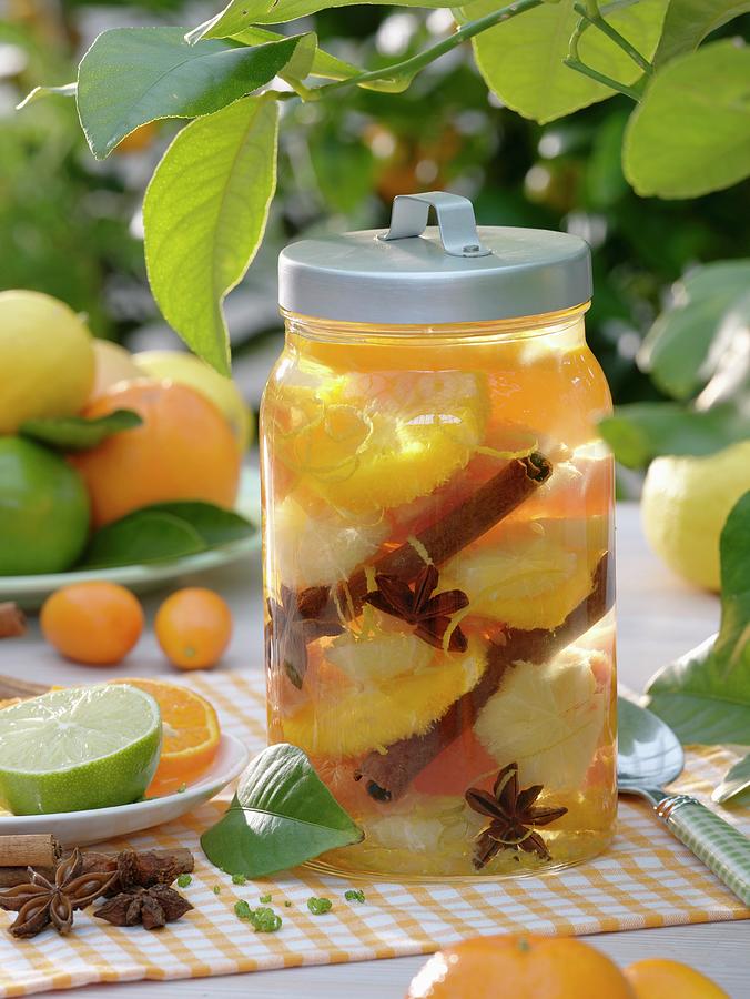 Bottled Citrus Fruit With Cinnamon Sticks And Star Anise Photograph by ...