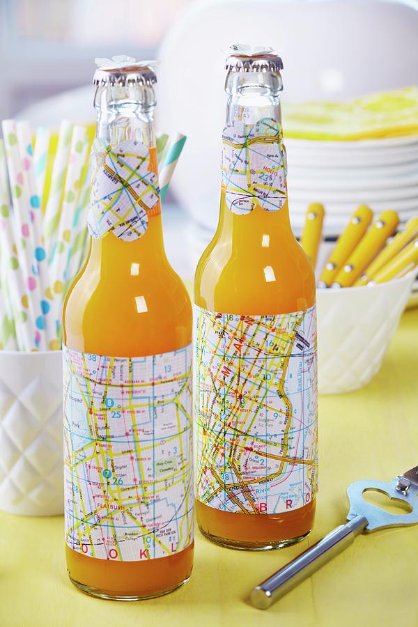 Bottles Decorated For Party - Sleeves And Flower-shapes Cut From Old Maps Photograph by Franziska Taube