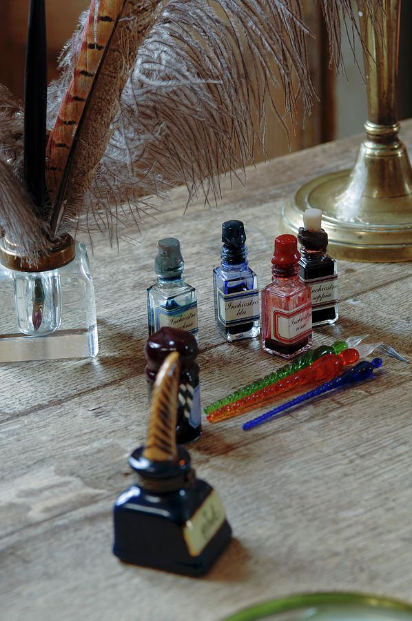 Bottles Of Different Coloured Inks And Quill Pens On Old Desk Photograph by Christophe Madamour