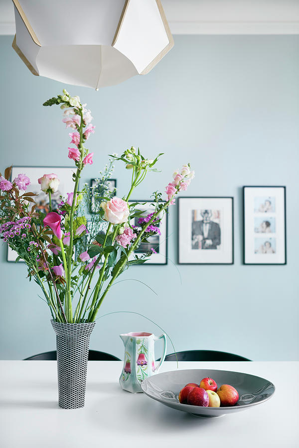 Bouquet In Shades Of Pink On Dining Table In Front Of Pale Blue Wall Photograph by Bjarni B. Jacobsen