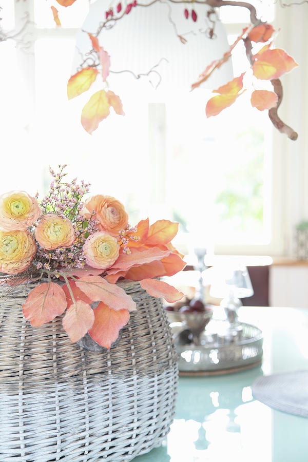Bouquet Of Apricot Ranunculus And Sea Lavender On Artificial Autumn Leaves Photograph by Sonja Zelano