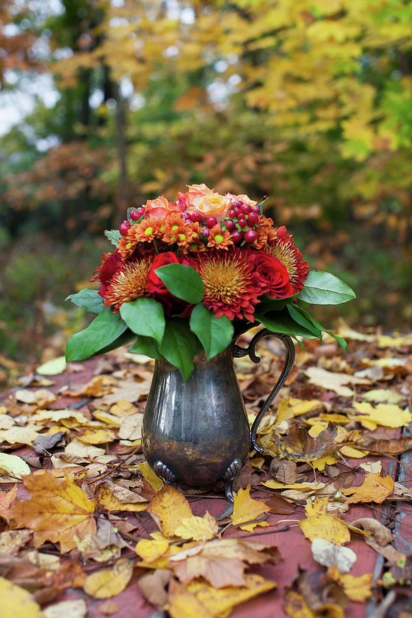 Bouquet Of Flowers In Silver Jug On Autumn Leaf Litter Photograph by Yelena Strokin