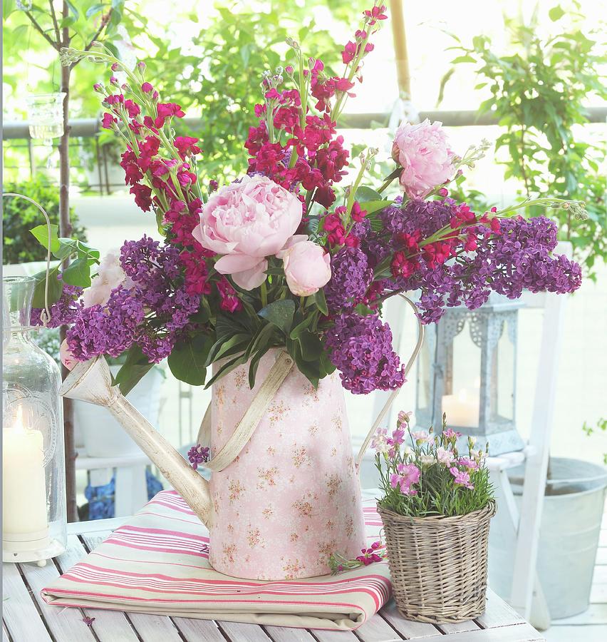 Bouquet Of Garden Flowers With Peonies, Stocks And Lilac In Retro Watering Can With Floral Pattern Photograph by Flowers & Green