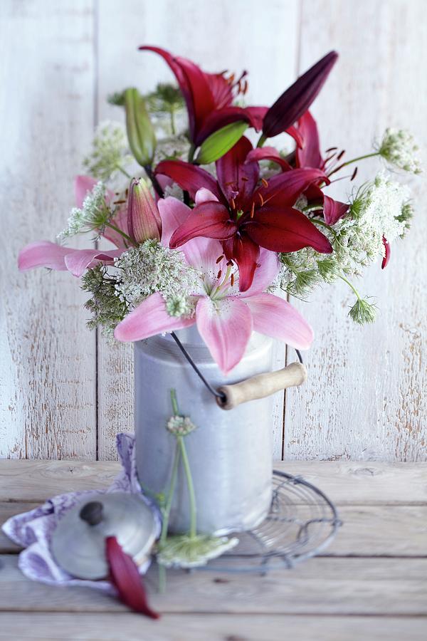 Bouquet Of Lilies And Wild Carrot In Old Milk Can Photograph by Anke Schtz