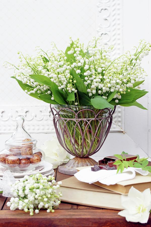 Bouquet Of Lily-of-the-valley In Vintage Metal And Glass Vase On Table Photograph by Angelica Linnhoff