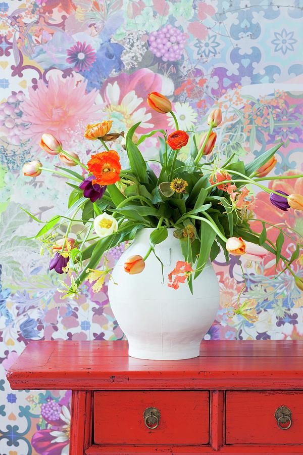 Bouquet Of Multicoloured Tulips On Red, Oriental Chest Of Drawers Against Floral Wallpaper Photograph by Peter Kooijman