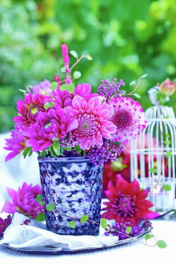 Bouquet Of Pink Dahlias In Silvered Glass Vase On Table Outdoors Photograph by Angelica Linnhoff