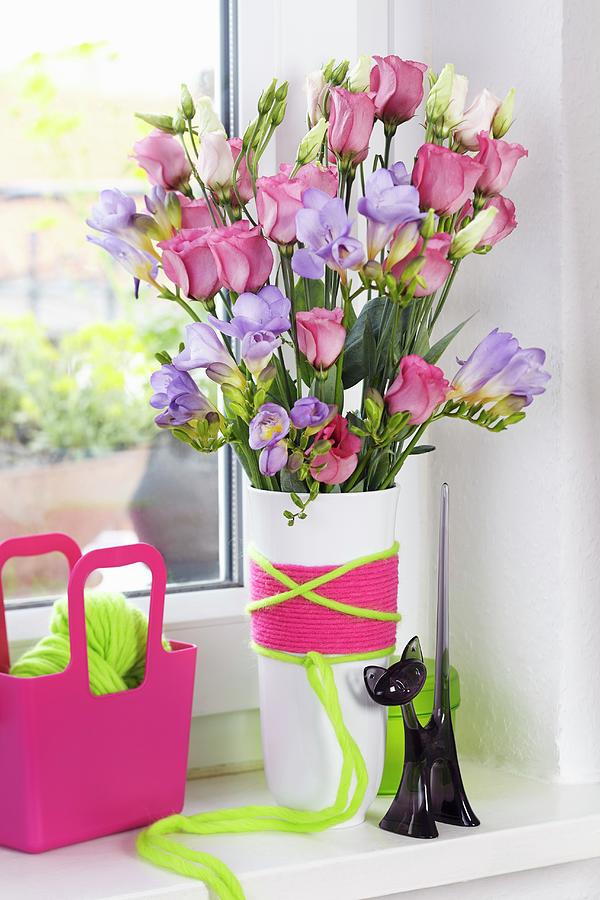 Spring Photograph - Bouquet Of Purple Freesias And Eustomas In Vase Wrapped In Colourful Woollen Yarn by Franziska Taube