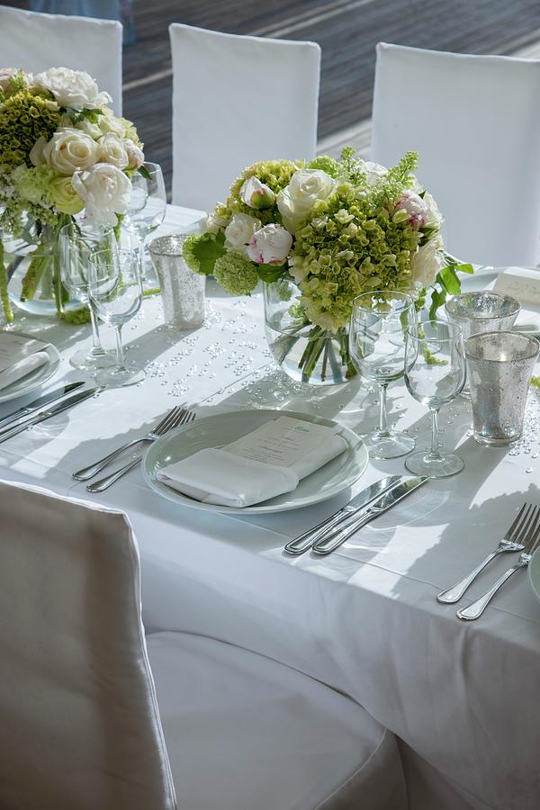 Bouquets Of White Roses On Festively Set Wedding Dinner Table With White Tablecloth Photograph by Christophe Madamour