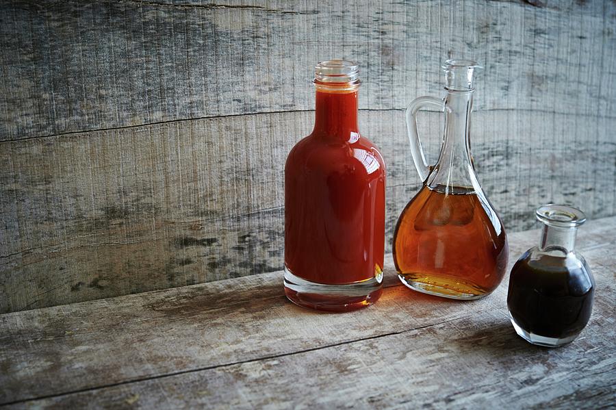Bourbon Barrel Aged Sauces; Vinegar Hot Sauce, Maple Syrup And Worcestershire Photograph by Rannells, Greg