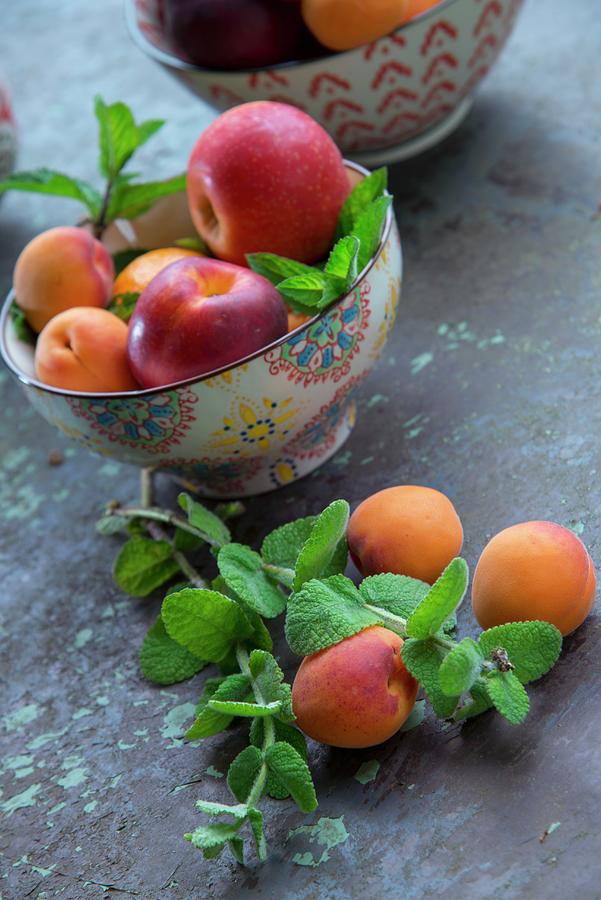 Bowl Of Apricots And Apples Photograph by Christophe Madamour