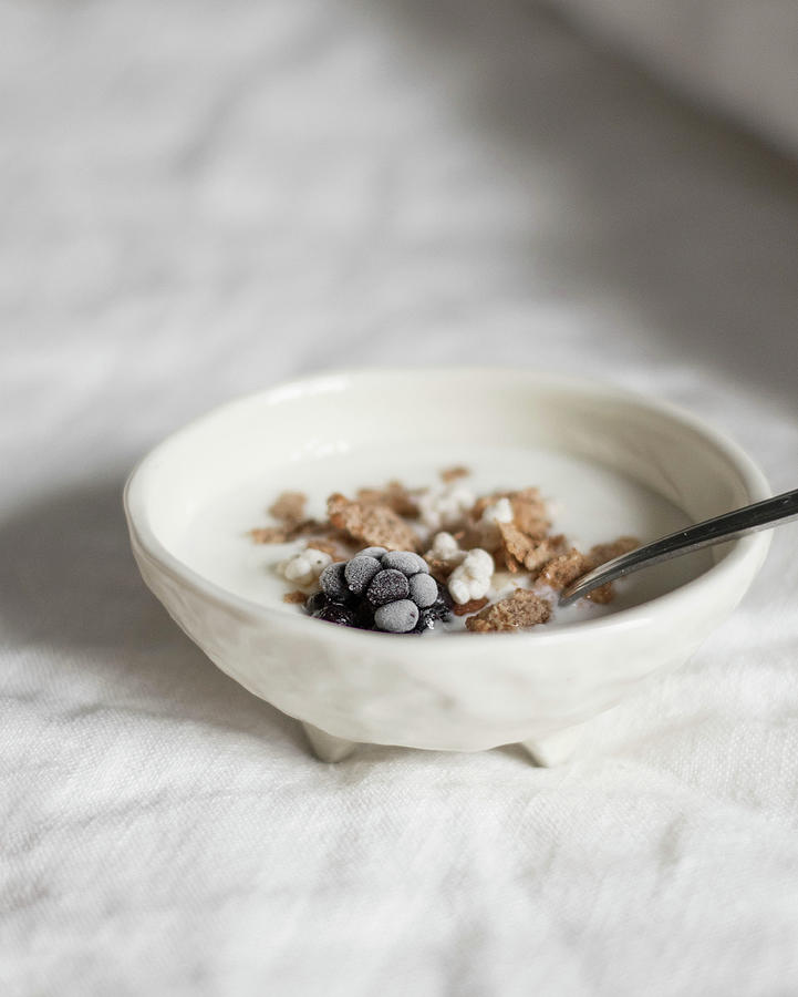 Bowl Of Cornflakes With Yoghurt And Frozen Blackberries Photograph by Agata Dimmich