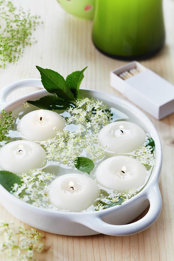 Bowl Of Floating Candles And Elderberry Flowers Photograph by Franziska Taube