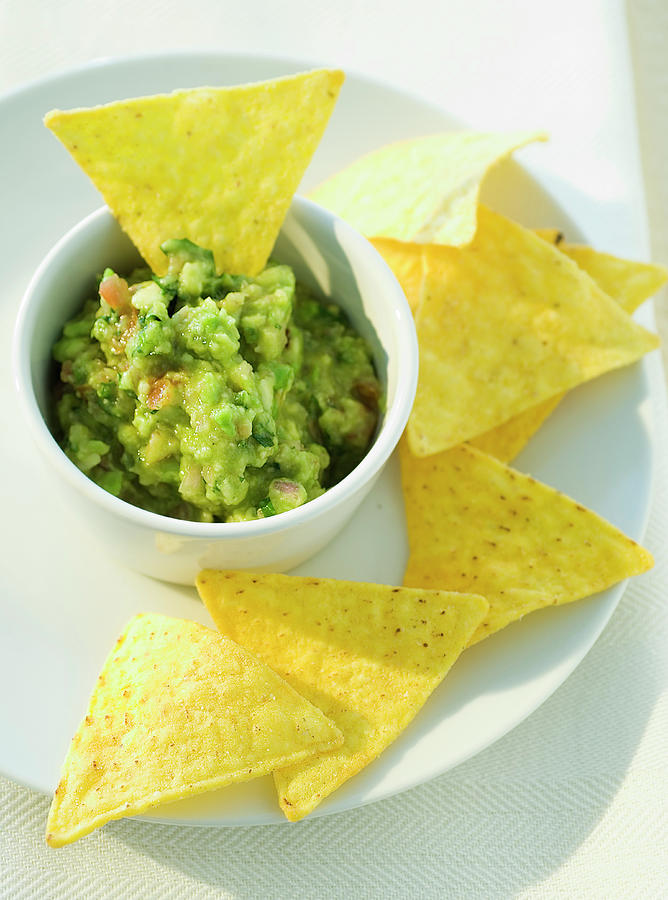 Bowl Of Guacamole With Corn Chips Photograph by Andreas Thumm