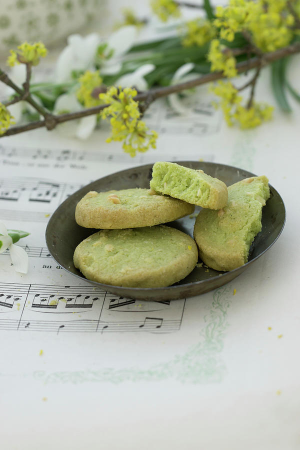 Bowl Of Pistachio Biscuits On Sheet Music Photograph by Martina Schindler