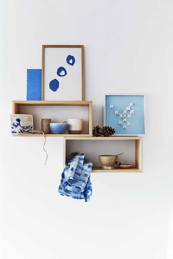 Bowls And Handmade Pictures In Blue And White On Wooden Shelves Photograph by Nicoline Olsen