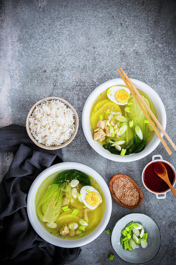 Bowls With Chinese Soup With Pak Choi, Chicken, Ginger, Potatoes And Spring Onions, Boiled Eggs And Sesame Seeds Photograph by Maricruz Avalos Flores