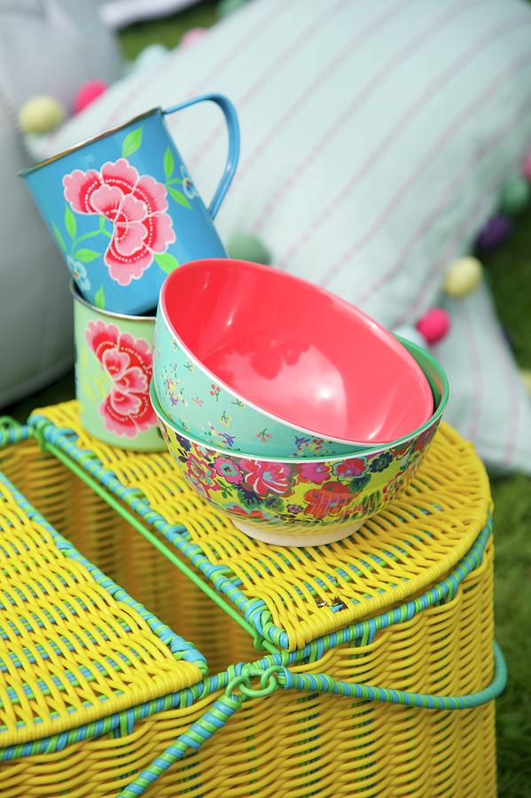 Bowls With Floral Patterns On Yellow Picnic Basket Photograph by Winfried Heinze