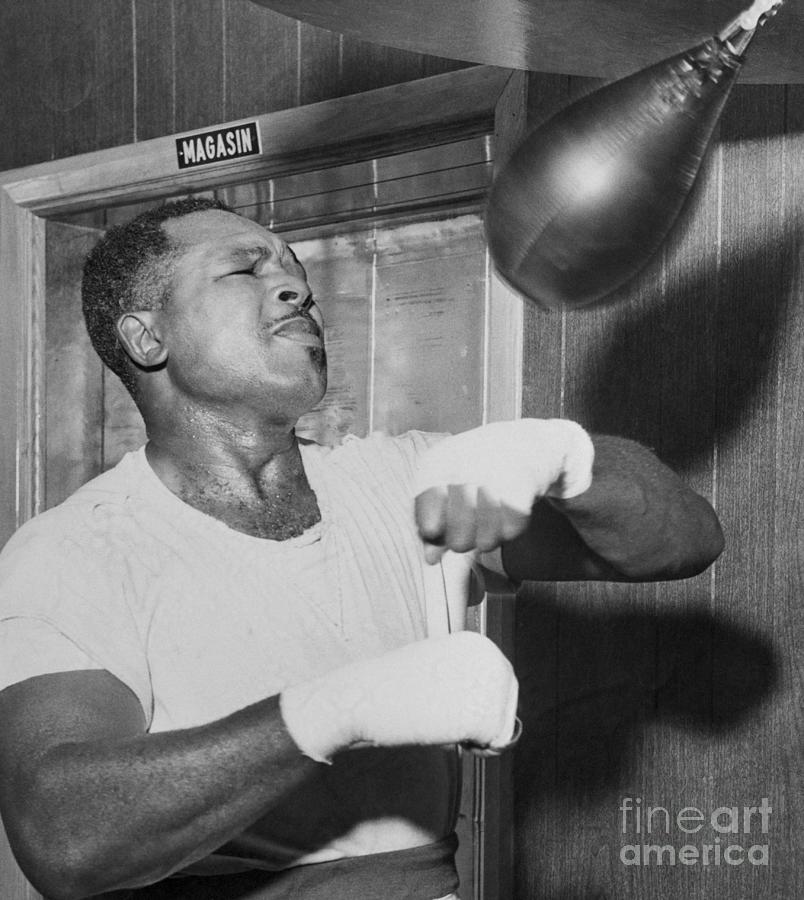 Boxer Archie Moore Using Punching Bag Photograph by Bettmann
