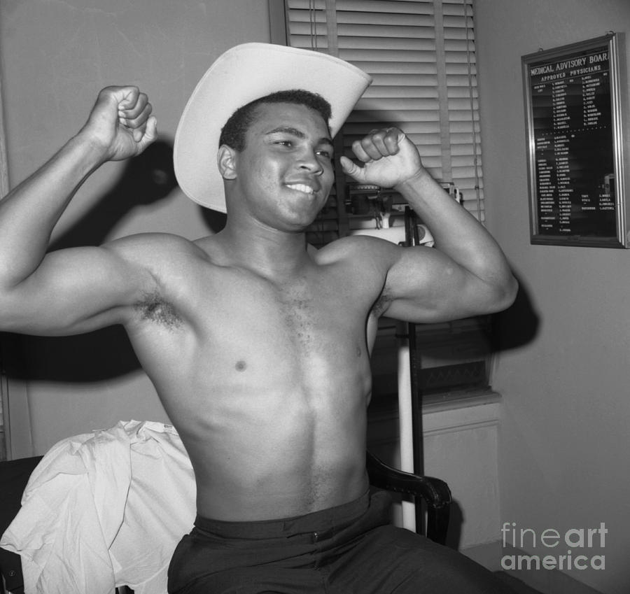 Boxer Cassius Clay Flexes His Muscles Photograph by New York Daily News Archive