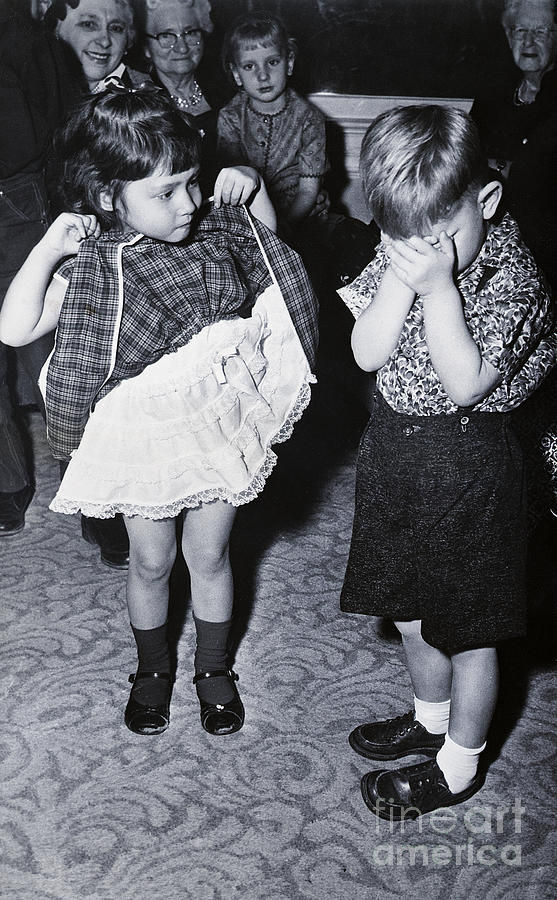 Boy Covering Eyes As Girl Raises Skirt Photograph by Bettmann