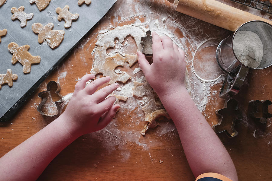 Christmas Photograph - Boy Cutting Out Gingerbread From Dough by Cavan Images