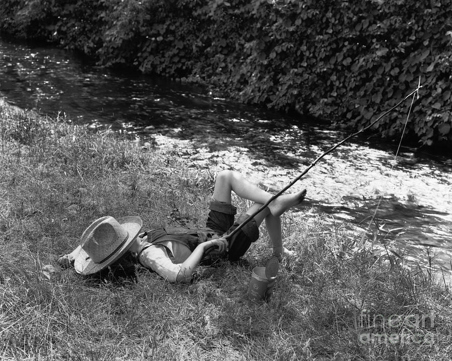 Boy Fishing With Hat Over Face Photograph by Bettmann