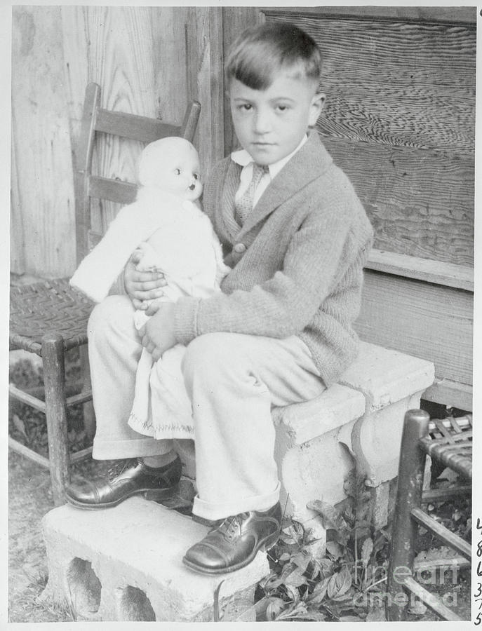 Boy Holding A Doll Photograph by Bettmann