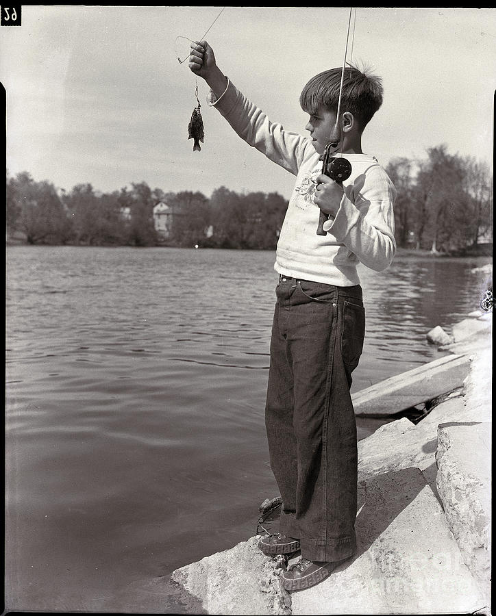 Boy Holding A Small Fish Photograph by Bettmann