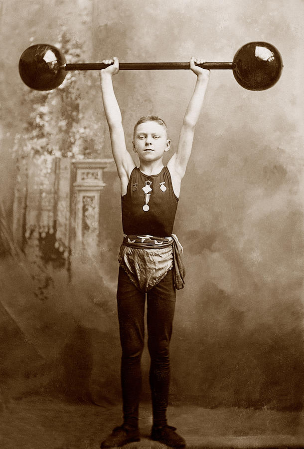 Boy Lifting Weights Photograph by Brand X Pictures