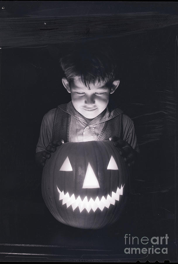 Boy Looking Into Jack Olantern Photograph by Bettmann