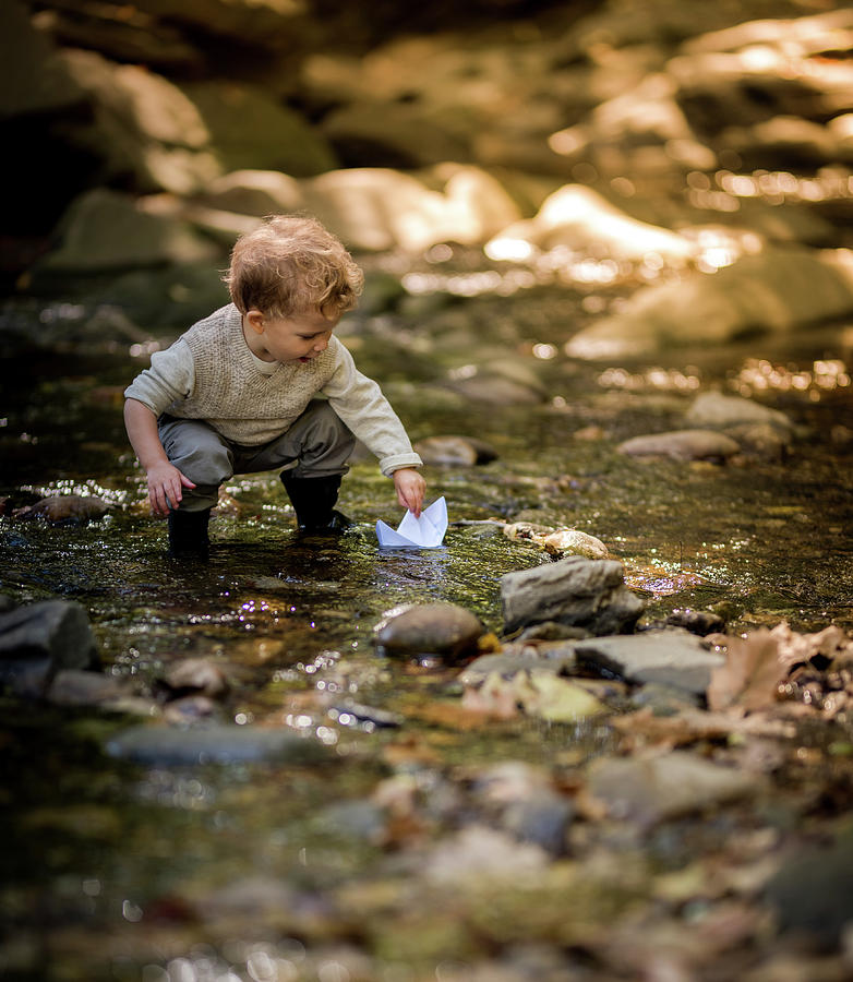 Boy Placing His Paper Boat In A Sun Dappled Stream Photograph by Cavan ...