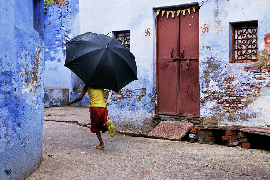 Boy Running In An Alley Holding An Photograph by Jeremy Woodhouse