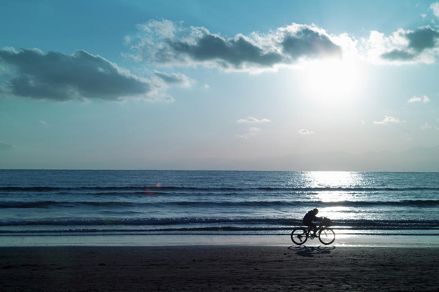 Boy Running On The Beach By Bicycle Photograph by Hiroshi Watanabe