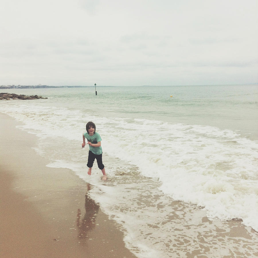 Boy Running Out Of Waves, Sandbanks Photograph by Jill Tindall