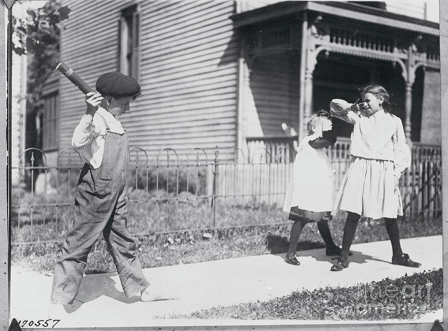 Boy Throwing Firecracker At Playmates Photograph by Bettmann