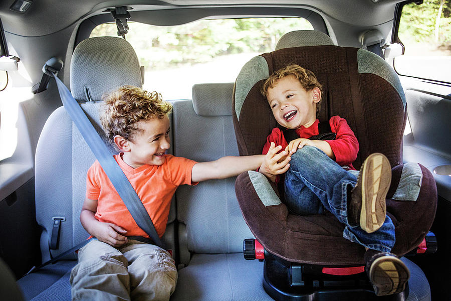 Boy Tickling Brother While Sitting In Car Photograph by Cavan Images ...